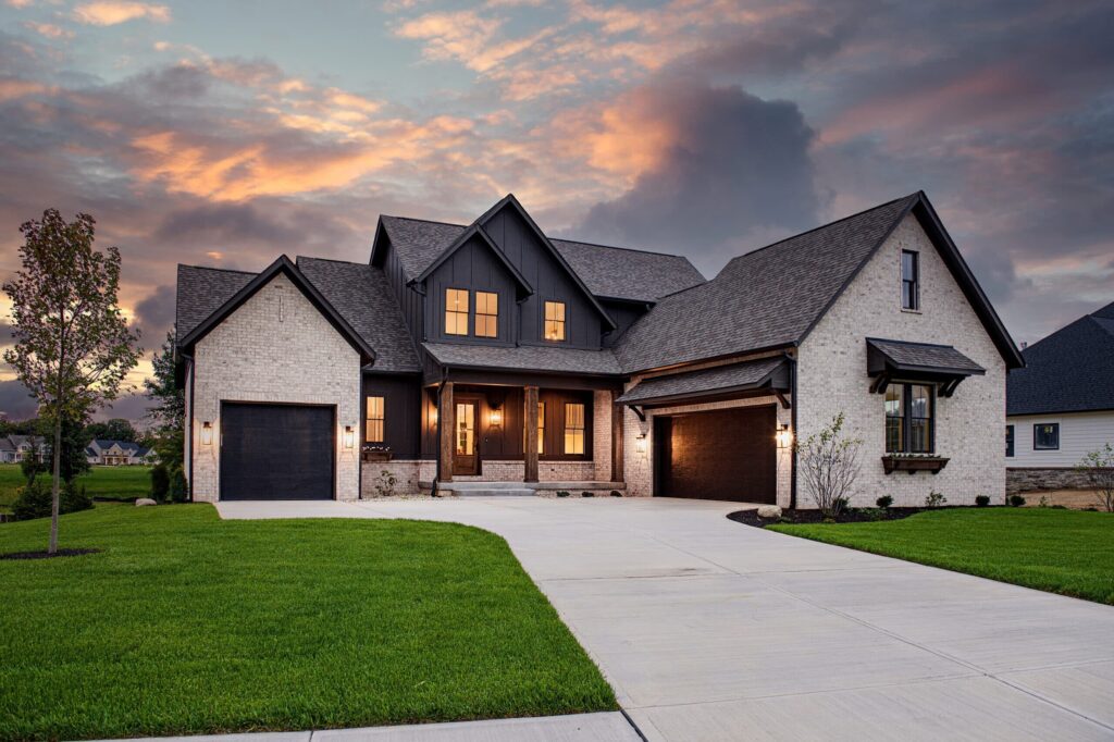 Modern custom-built home at sunset by top-rated Construction Company in Abbotsford, featuring elegant architecture, double garage, and manicured lawn.