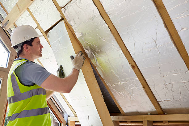 Contractor installing thermal insulation panels in attic space — insulation services in Surrey for improved energy efficiency and home comfort.
